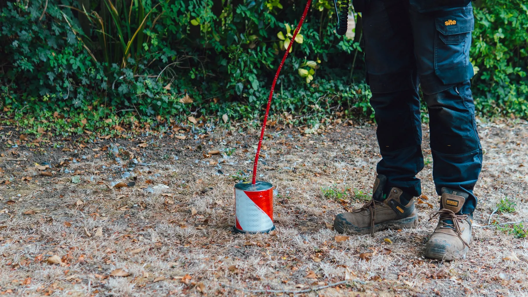 ADI engineer checking the ground with a red tracer gas detector probe